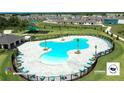 Aerial view of a resort-style pool with surrounding lounge chairs and a playground at 5688 Siltstone St, Lakeland, FL 33811