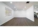 Bright and airy living room featuring new laminate flooring and recessed lighting at 3733 Hill St, Lakeland, FL 33812