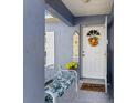 Inviting front entrance with a white door, sunflower wreath, and decorative bench at 2986 Sw 143Rd Place Rd, Ocala, FL 34473