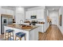 Modern kitchen island with stainless steel appliances at 239 Puma Loop, Groveland, FL 34736