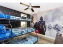 bedroom with Star Wars themed bunk beds and wall mural at 7650 Fairfax Dr, Kissimmee, FL 34747