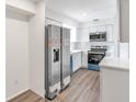 Bright kitchen with updated stainless steel appliances and light grey cabinets at 7340 Daniel Webster Dr # 6, Winter Park, FL 32792