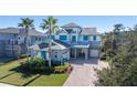 Two-story home with gray siding, blue shutters, and a paver driveway at 9406 Dugard Ct, Orlando, FL 32827
