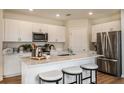 Modern kitchen with white cabinets, stainless steel appliances, and an island at 3848 King Hill Dr, Haines City, FL 33844