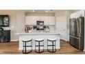 Modern kitchen with white cabinets, stainless steel appliances and an island at 3848 King Hill Dr, Haines City, FL 33844