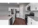 Modern kitchen with stainless steel appliances and white cabinets at 1422 Derry Ave, Haines City, FL 33844