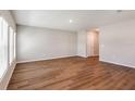 Spacious living room with wood-look flooring and neutral walls at 1422 Derry Ave, Haines City, FL 33844