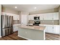 Modern kitchen with white cabinets, stainless steel appliances and an island at 4010 Gardenia Ave, Lake Hamilton, FL 33851