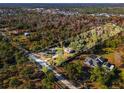 Aerial view of a house nestled within a sprawling wooded lot at 2468 Fawn Run, Oviedo, FL 32765