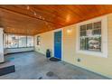 Bright front porch with blue door and wood ceiling at 514 W Hancock St, Lakeland, FL 33803