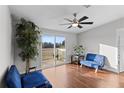 Bright bedroom with wood floors and sliding glass doors leading to a deck at 7435 Postal Colony Rd, Clermont, FL 34714