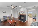 Spacious living area with fireplace and access to a deck at 7435 Postal Colony Rd, Clermont, FL 34714