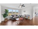 Spacious living room with wood floors, large windows and comfortable seating at 7435 Postal Colony Rd, Clermont, FL 34714