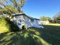 Side view of a ranch home with a spacious yard at 4805 Sand Mountain Loop Rd, Auburndale, FL 33823