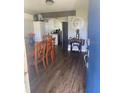 Bright dining area with wood floors and a view of the kitchen at 1486 S Us 301, Sumterville, FL 33585