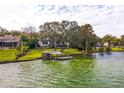 Scenic aerial view showcasing the home's waterfront location and private dock at 1212 Lake Point Dr, Lakeland, FL 33813