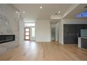 Light filled living room with hardwood floors and marble fireplace at 3225 Parkwood Ct, Kissimmee, FL 34744
