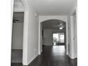 Bright entryway with dark hardwood floors and arched doorways at 1051 Woodlark Dr, Haines City, FL 33844