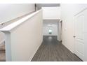 Bright entryway with grey wood-look floors and staircase at 13477 Leaping Water Way, Astatula, FL 34705