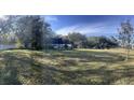 Spacious backyard with large grassy area and home in background at 6611 Hereford Dr, Lakeland, FL 33810