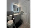 Modern bathroom with gray vanity and tiled floors at 3928 Calabria Ave, Davenport, FL 33897