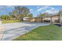 Covered carport and driveway with additional parking space at 2104 W End Ave, Lakeland, FL 33803