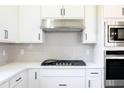 Modern kitchen featuring white shaker cabinets, stainless steel appliances, and a gas cooktop at 7837 Somersworth Dr, Kissimmee, FL 34747