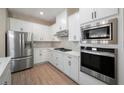 Modern kitchen featuring stainless steel appliances, white cabinetry, and quartz countertops at 7865 Somersworth Dr, Kissimmee, FL 34747