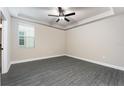 Spacious main bedroom with wood-look flooring and neutral paint at 7752 Somersworth Dr, Kissimmee, FL 34747