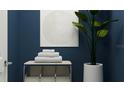 Stylish bathroom with dark blue walls, white towels, and a potted plant at 7005 Rosy Sky Ave, Orlando, FL 32829