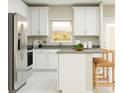 Bright kitchen features white shaker cabinets, stainless steel appliances, and an island at 7005 Rosy Sky Ave, Orlando, FL 32829