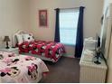 ' bedroom with two twin beds, Minnie Mouse theme, and white wicker furniture at 409 Lucaya Loop # 409, Davenport, FL 33897