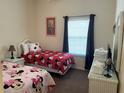 ' bedroom featuring two twin beds with Minnie Mouse bedding and a window at 409 Lucaya Loop # 409, Davenport, FL 33897