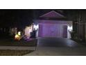 Two-story home with festive lights, two-car garage, and brick paver driveway at 1263 Verdant Glade Pl, Winter Park, FL 32792