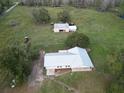 Aerial view showing home, detached workshop, and acreage at 4915 Mount Pleasant Rd, Groveland, FL 34736