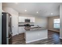 Modern kitchen with white cabinets, gray countertops, and stainless steel appliances at 1106 Foreshore Ln, Haines City, FL 33844
