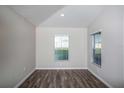 Bright office space with wood-look flooring and two large windows at 1106 Foreshore Ln, Haines City, FL 33844