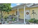 Inviting front porch with white railings and landscaping at 136 Cory Ct, Auburndale, FL 33823