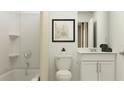 Simple bathroom with white vanity, tub shower combo and beige shower curtain at 853 Hour Glass Rd, Lakeland, FL 33801