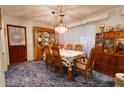 Classic dining room with wooden table and chairs, and built-in hutch at 6085 Amaryllis Dr, Indian Lake Estates, FL 33855