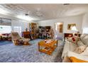 Living room features a large TV, comfortable seating, and a spacious layout at 6085 Amaryllis Dr, Indian Lake Estates, FL 33855