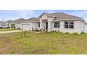 House exterior showcasing a light-colored facade and neatly landscaped yard at 840 S Palm Ave, Frostproof, FL 33843