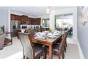 Elegant dining room with a large wooden table and six chairs at 1534 Carey Palm Cir, Kissimmee, FL 34747