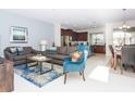 Open living space with gray sofas, blue armchair, and kitchen views at 1534 Carey Palm Cir, Kissimmee, FL 34747