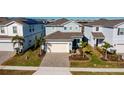 Two-story house, paved driveway, and landscaping in a residential neighborhood at 1166 Aloha Blvd, Davenport, FL 33897