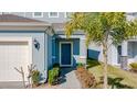 Dark blue front door, walkway, and landscaping at 1166 Aloha Blvd, Davenport, FL 33897