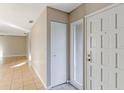 Light and airy entryway with tile flooring and coat closet at 618 El Camino Real S, Lakeland, FL 33813