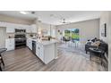 Open concept kitchen with island and stainless steel appliances at 745 Jaybee Ave, Davenport, FL 33897