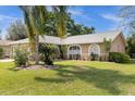 Tan house with a two-car garage and lush landscaping at 2739 Everleth Dr, Lakeland, FL 33810