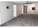 Spacious living room with grey carpet and ceiling fan at 333 Lake Howard Nw Dr # 204C, Winter Haven, FL 33880